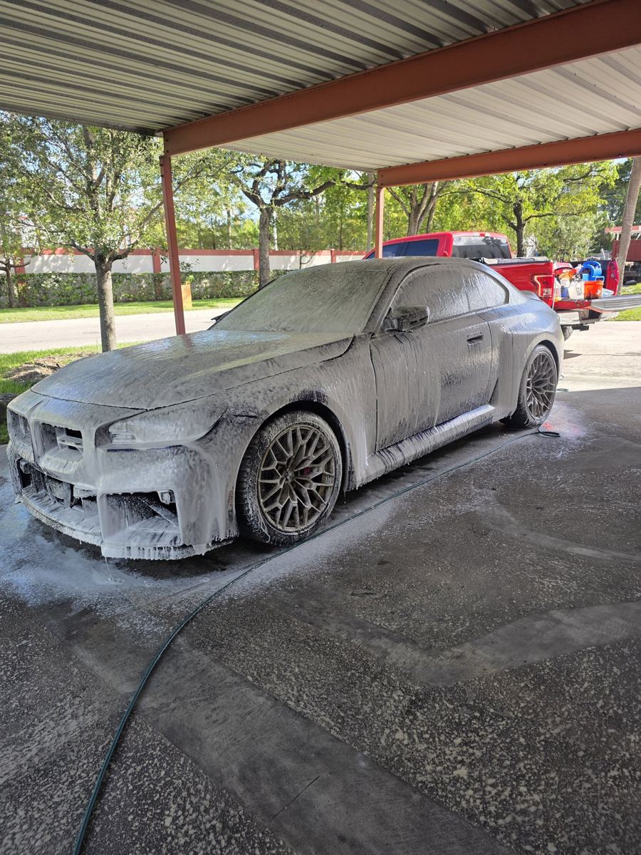 BMW M2 covered in foam during a mobile hand wash