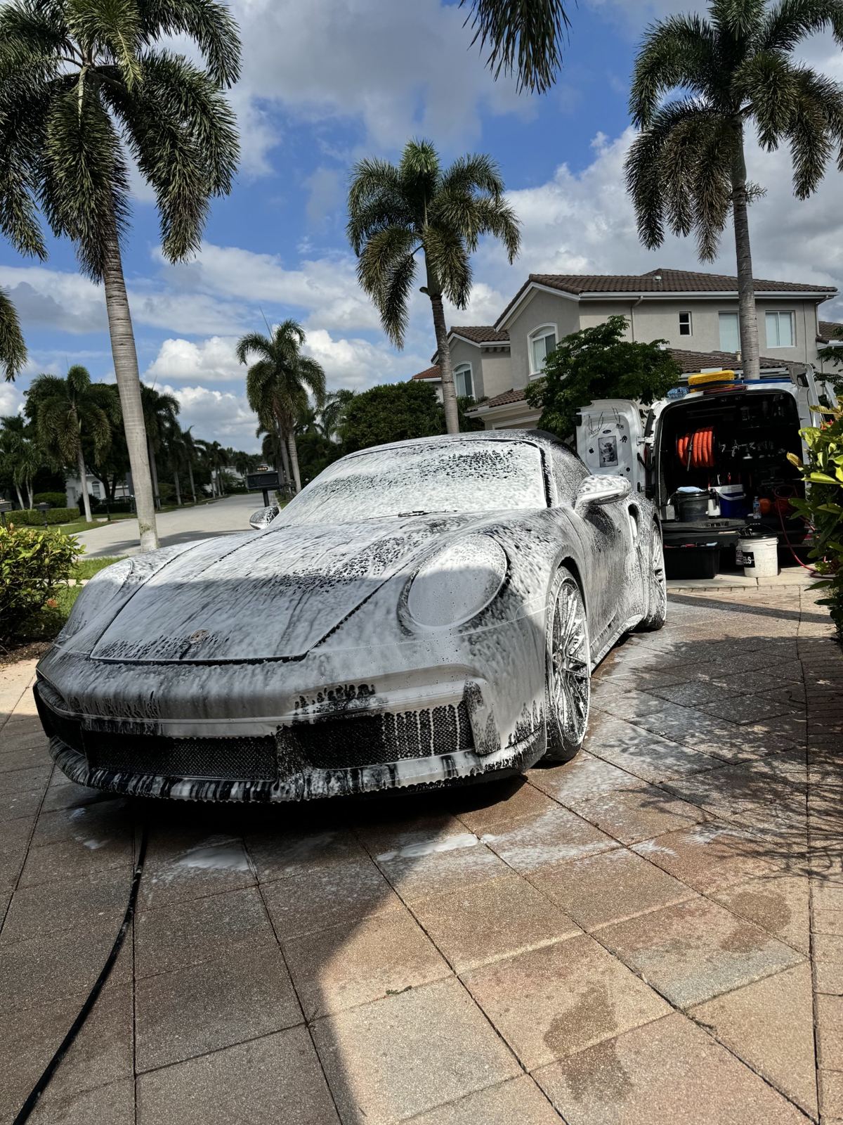 Porsche 911 foam wash in a Broward County driveway with the Detail Bros van