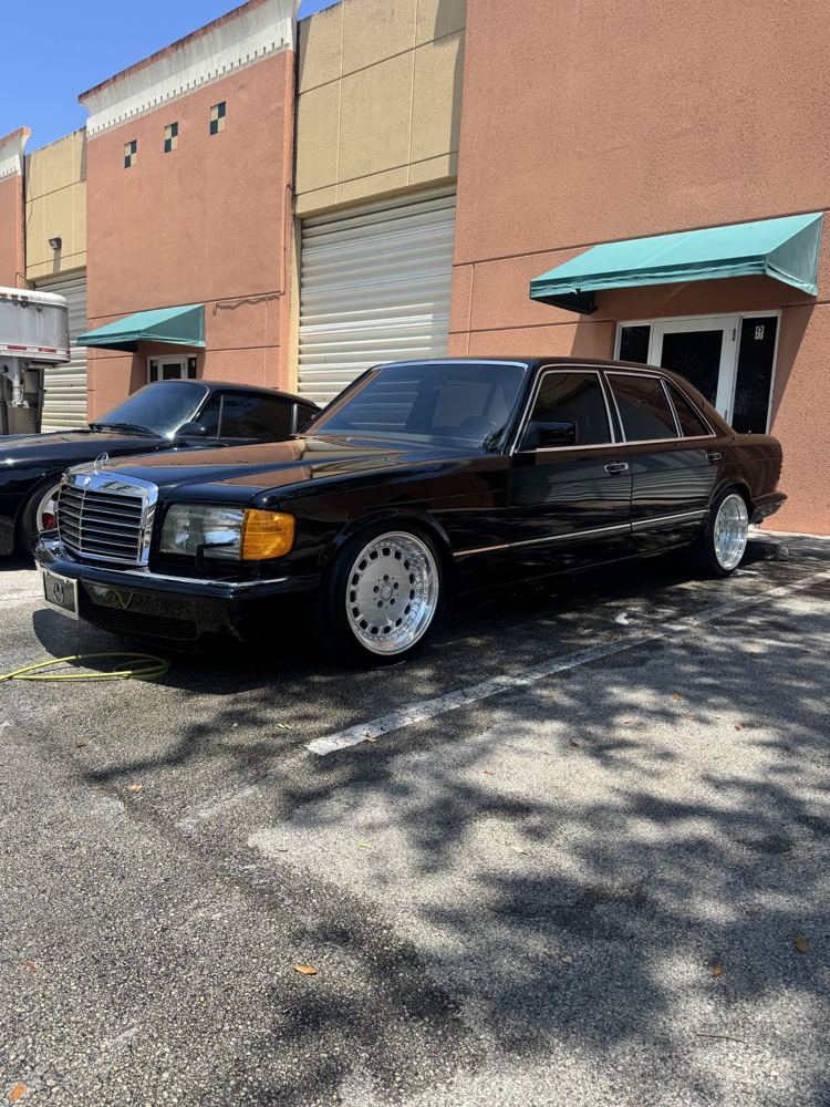 Black classic Mercedes S-Class with polished wheels